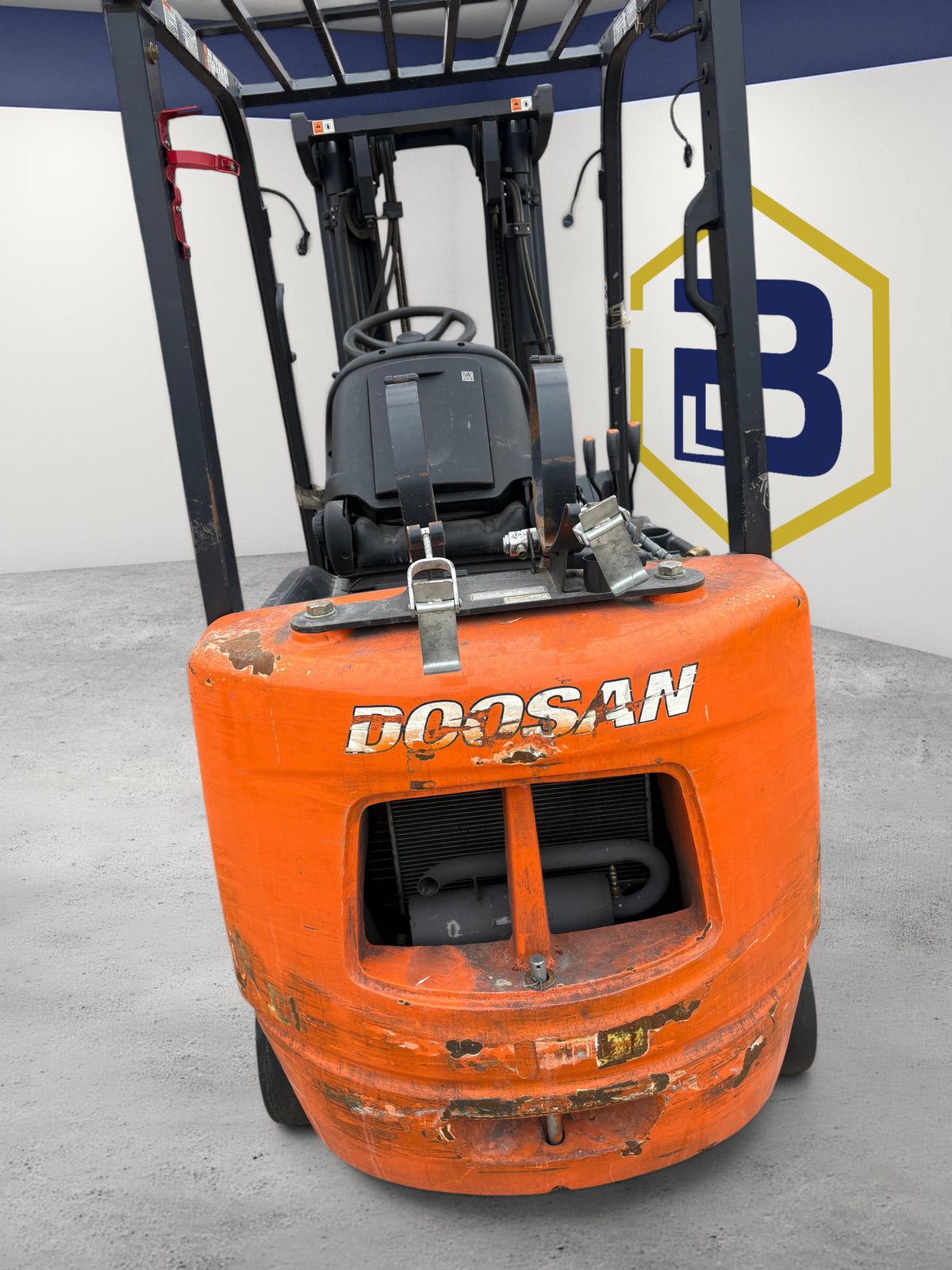 Burwell Material Handling 2003 Doosan GC25E-3LP orange LPG cushion-tire forklift, rear view showing engine compartment