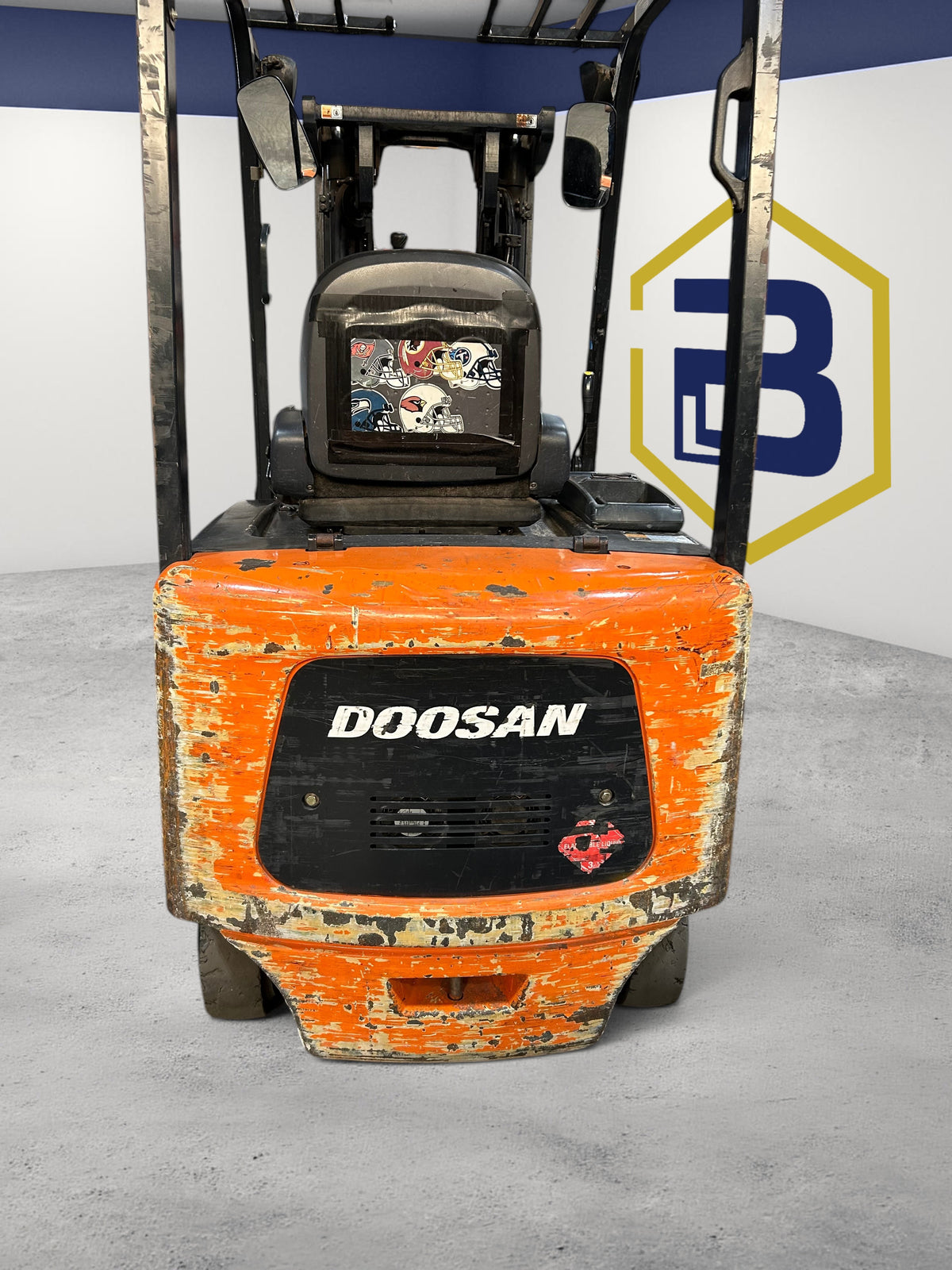 Burwell Material Handling 2000 Doosan BC25S-5 electric sit-down forklift with orange chassis in warehouse setting