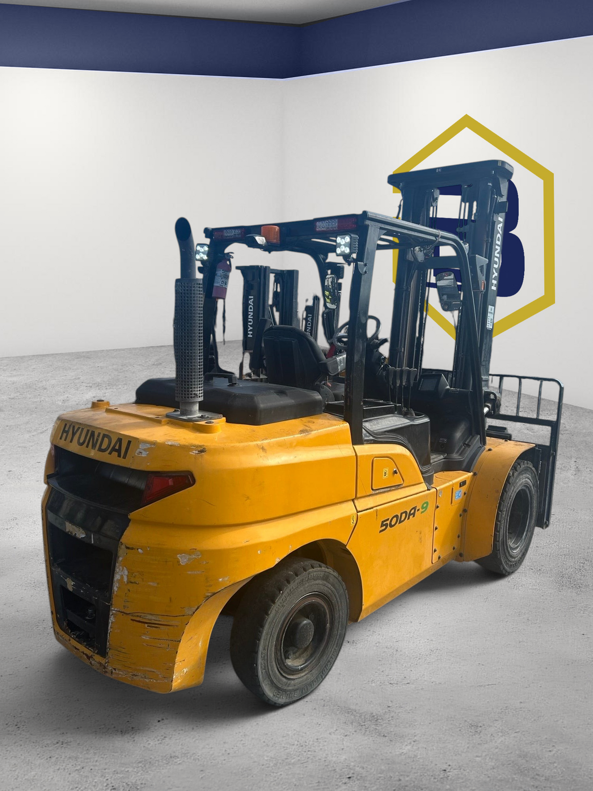 Burwell Material Handling yellow Hyundai 50DA-9 diesel pneumatic forklift parked in an outdoor equipment yard.