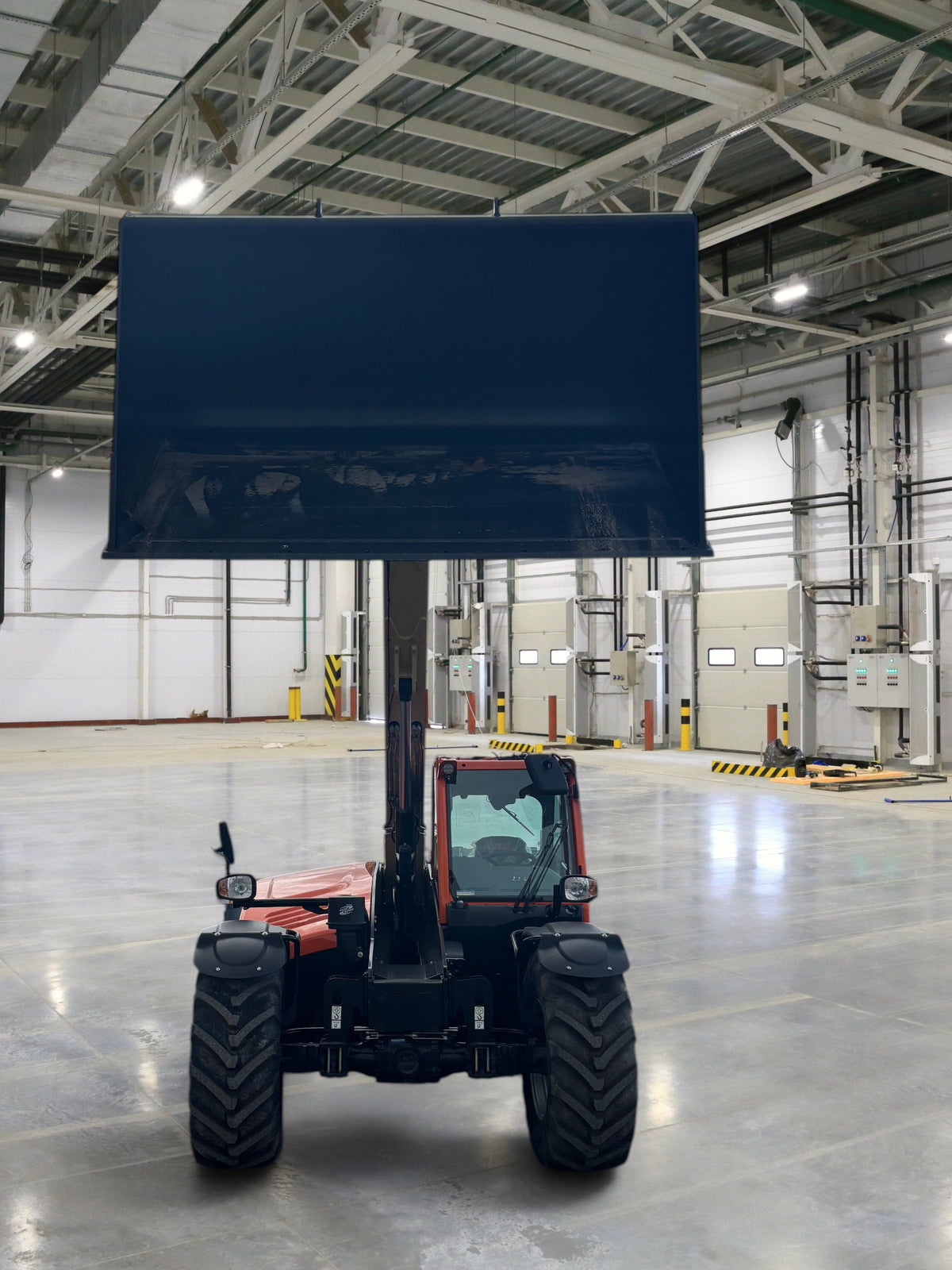 Burwell Material Handling 2024 JLG 823 Ag telehandler with a large front bucket raised in an outdoor gravel lot.