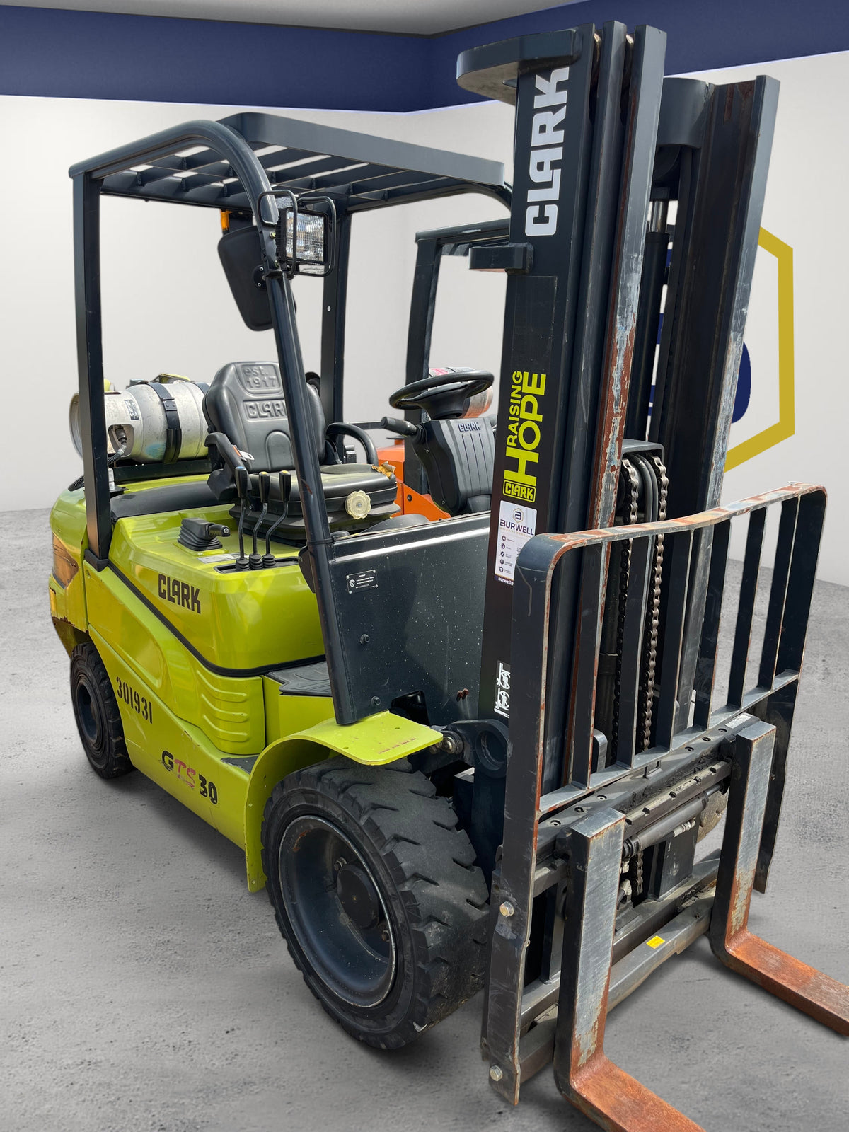 Burwell Material Handling 2022 CLARK GTS30 pneumatic tire forklift in lime green parked in an outdoor industrial yard