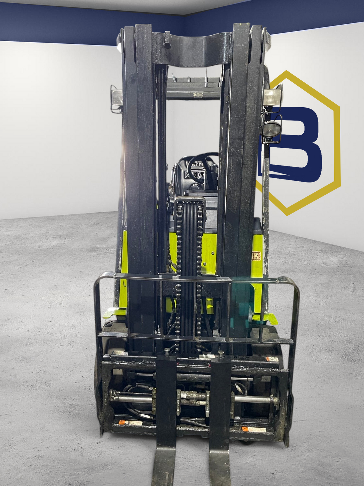 Burwell Material Handling CLARK ECX25 electric sit-down forklift with black mast and green chassis in warehouse