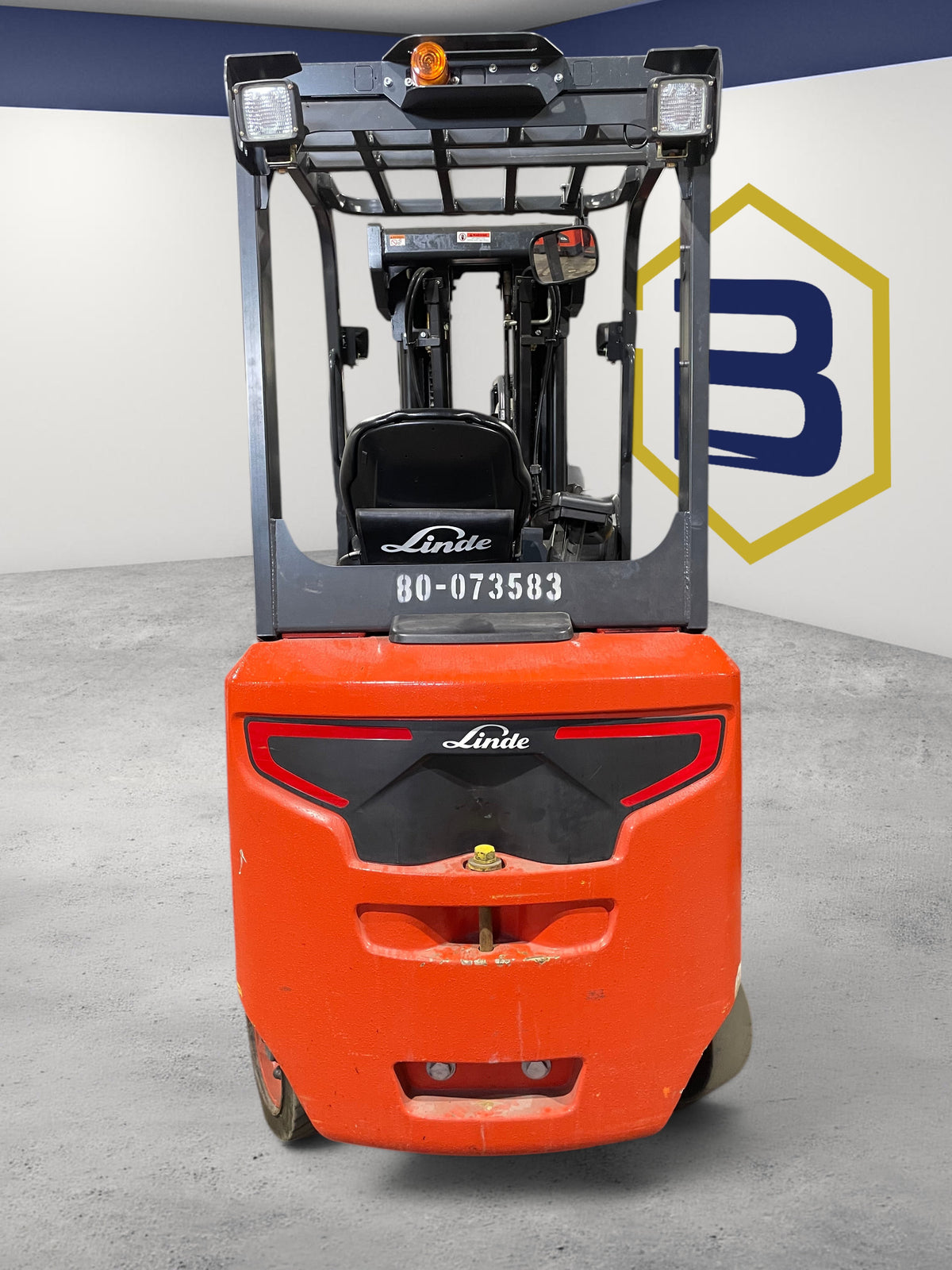 Rear view of a red 2020 Linde E25C electric cushion-tire forklift from Burwell Material Handling in a warehouse.