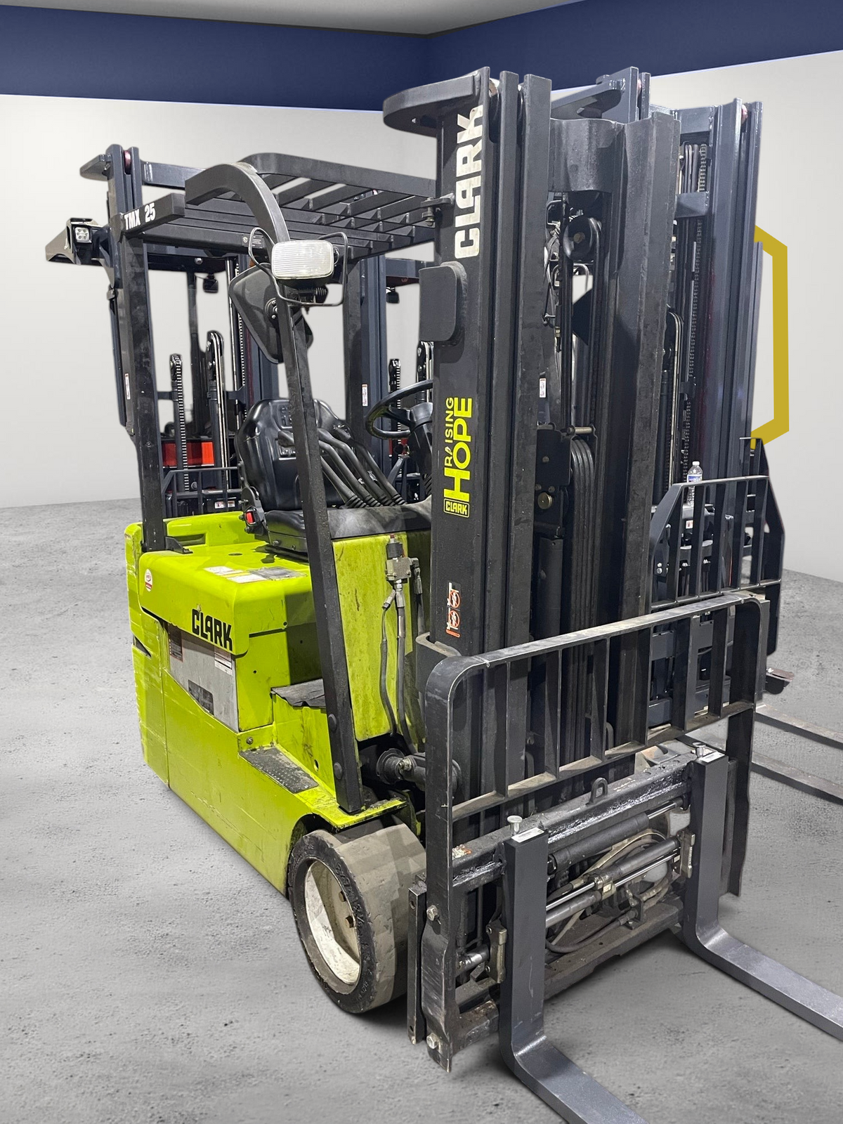 Burwell Material Handling 2021 Clark TMX25 3-wheel electric forklift in lime green with black mast in a warehouse.