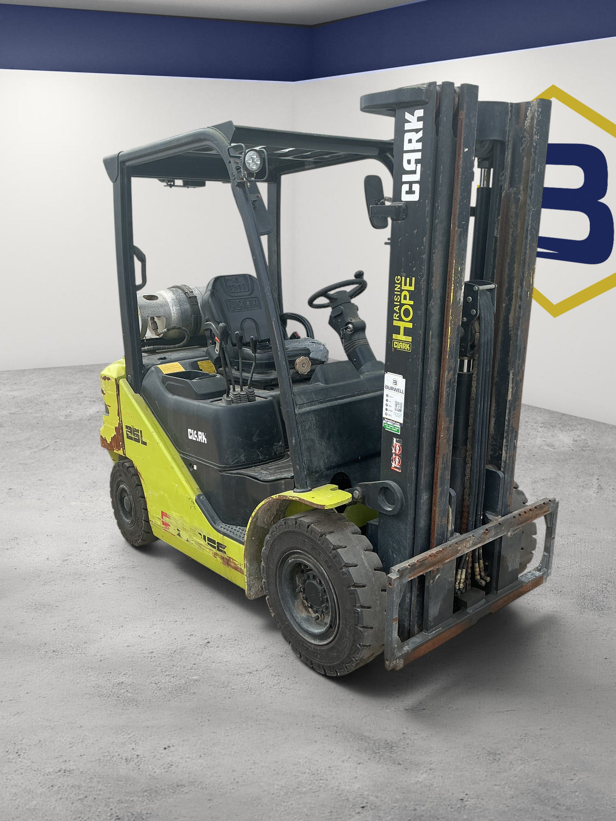 Burwell Material Handling 2014 CLARK S25 pneumatic-tire forklift with yellow and black finish in an indoor warehouse