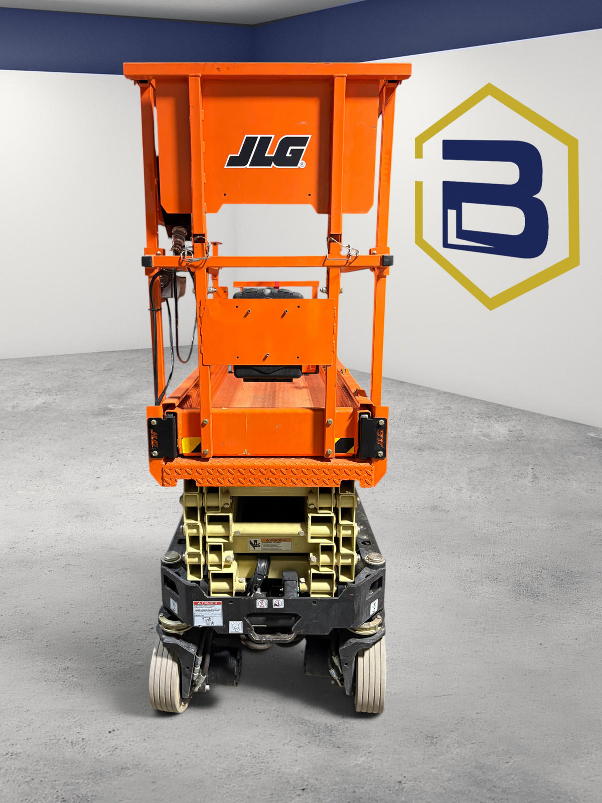 Burwell Material Handling 2022 JLG R1932 electric scissor lift in orange, viewed from the rear in a warehouse.