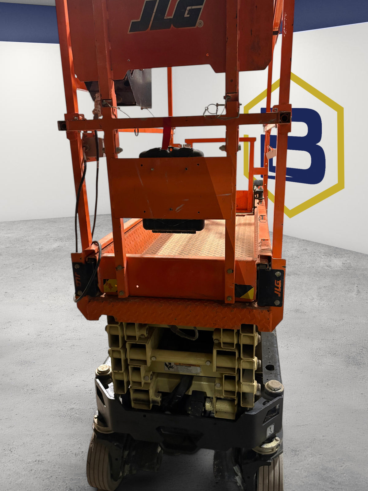 Burwell Material Handling 2022 JLG R1932 electric scissor lift, rear view showing the compact orange steel chassis