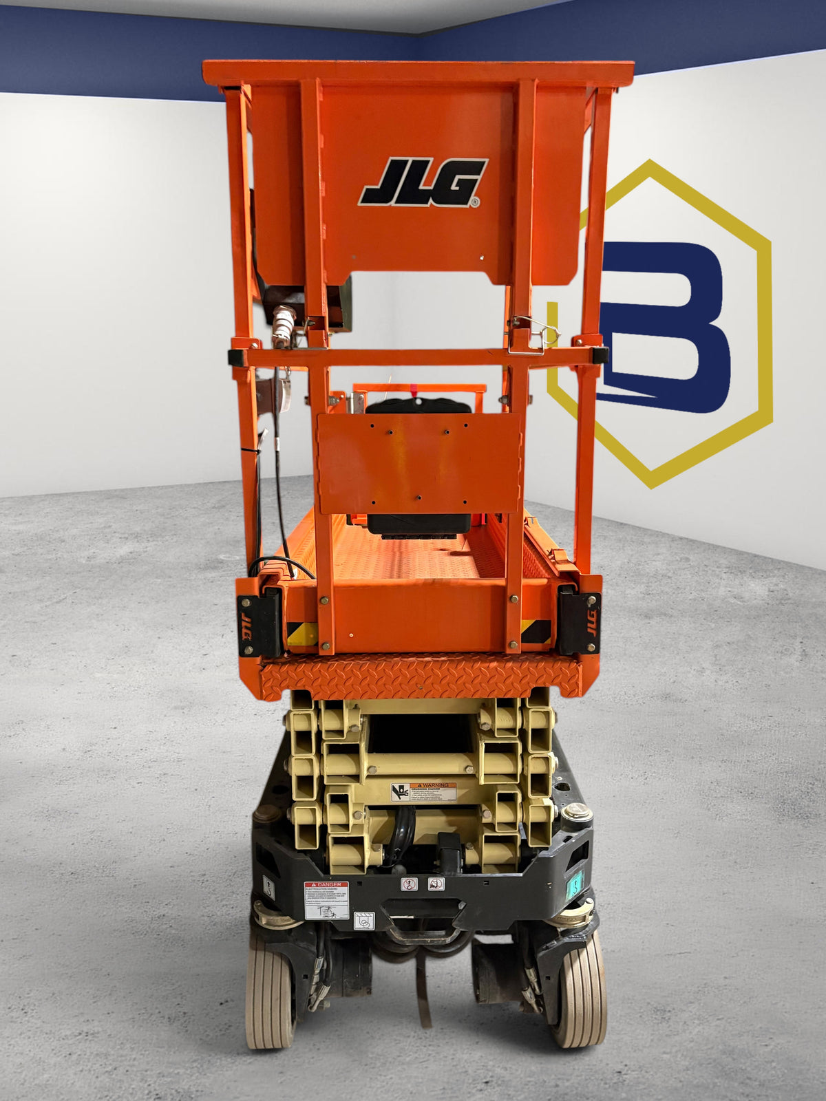 Burwell Material Handling 2022 JLG R1932 electric scissor lift in orange, viewed from the rear in a warehouse.